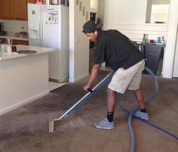Technician Removing Water From Carpet